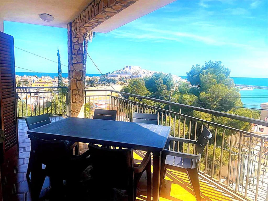 a table on a balcony with a view of the ocean at Urmi 8 Vista Mar in Peniscola