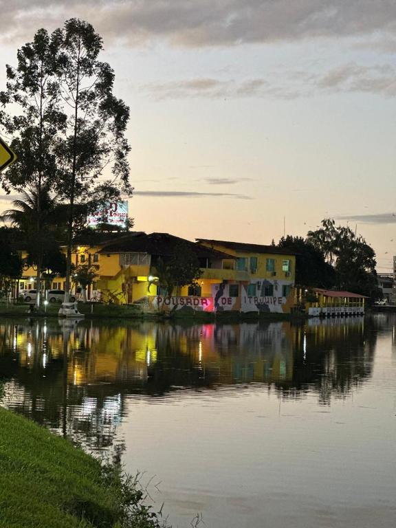a group of houses next to a body of water at Pousada de Itajuípe em Itajuípe in Itajuípe