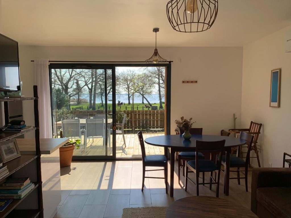 a kitchen and dining room with a table and chairs at Le Moutchic in Lacanau