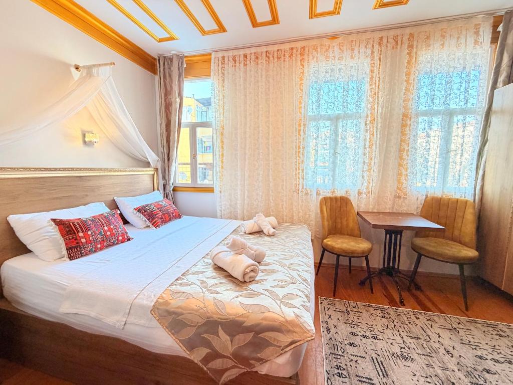 a bedroom with a bed with two stuffed animals on it at April Mansion in Istanbul