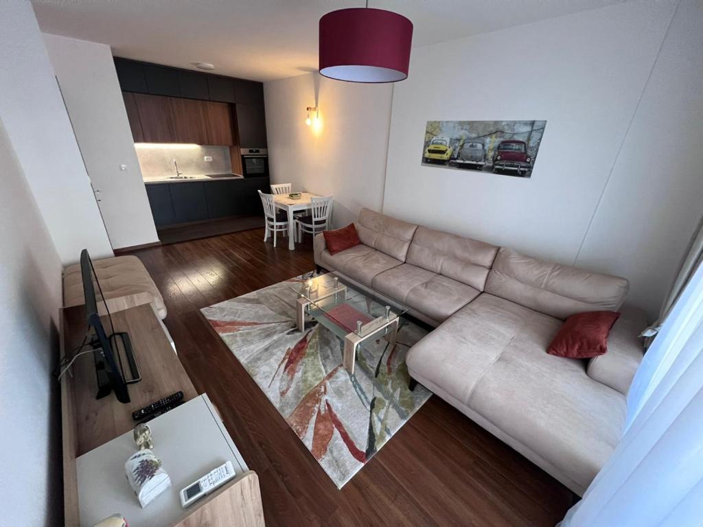 a living room with a couch and a table at Podgorica Royal Apartment in Podgorica