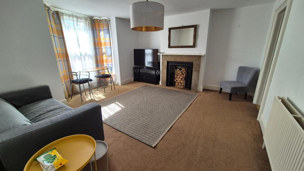 a living room with a couch and a fireplace at Spacious Central Reading Flat, 2 Double Beds, Wi-Fi, Parking in Reading