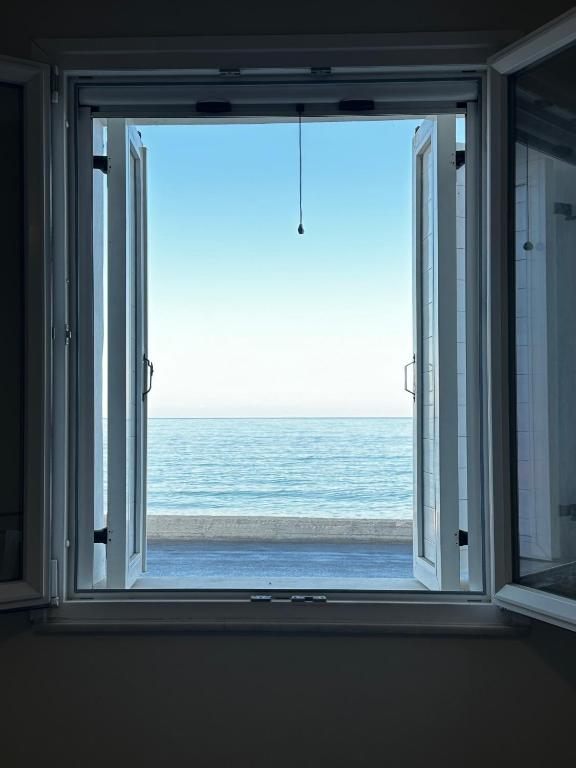 an open window with a view of the ocean at Koralis in Petra