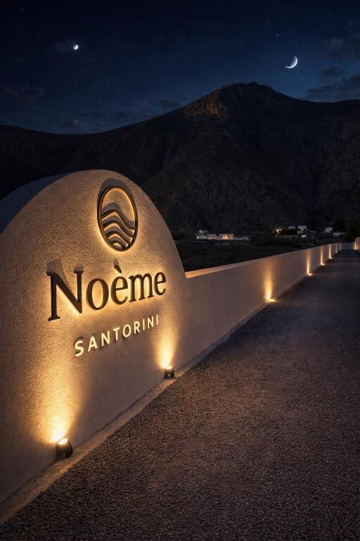 a sign that says noono santorini with lights at Noème Santorini in Perissa
