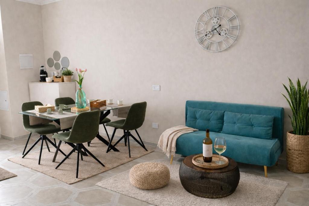 a living room with a blue couch and a table at La Madonnella Home - locazione turistica in Adelfia