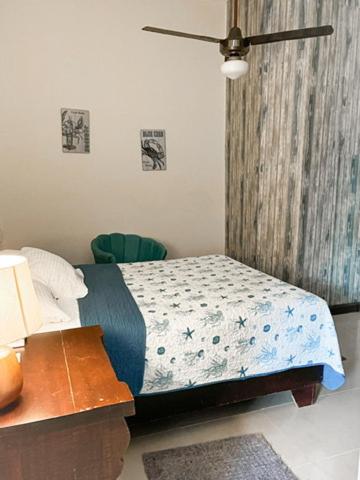 a bedroom with a bed and a table with a night stand at The Boat House in Boca Chica