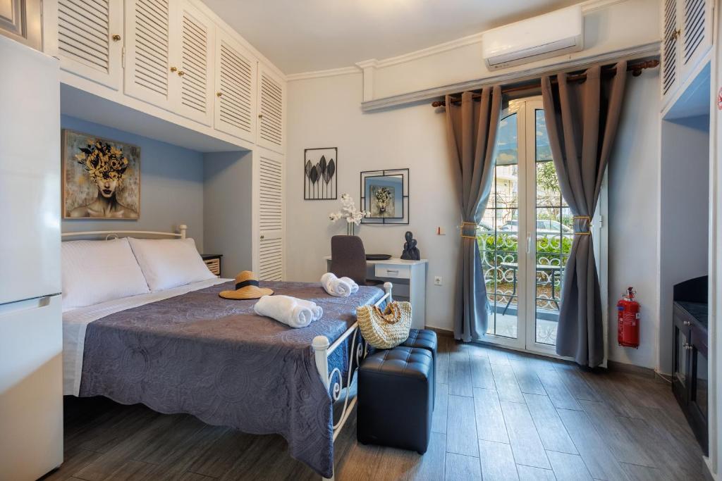 a hotel room with a bed and a balcony at Corfu Bay Serenity Suite in Ágios Rókkos