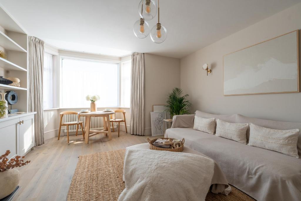 a living room with a couch and a table at Blu's Seaview Apartment in Rhos-on-Sea