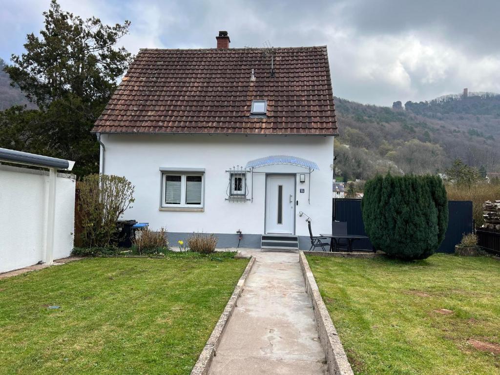 a white house with a brown roof at Ferienhaus mit Trifelsblick in Annweiler am Trifels