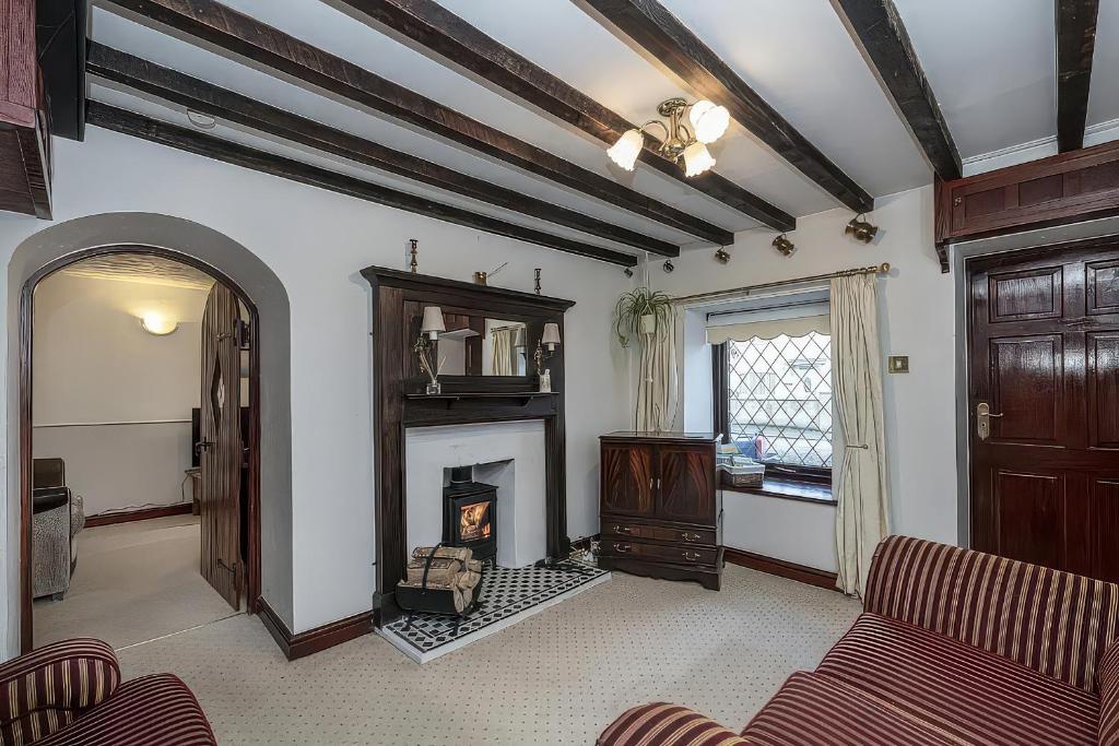 a living room with a fireplace and a couch at Preswylfa in Cemaes Bay