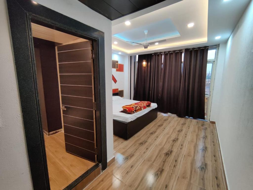 a small bedroom with a bed and a mirror at 7 Vachan Garden and Resort in Bhopal