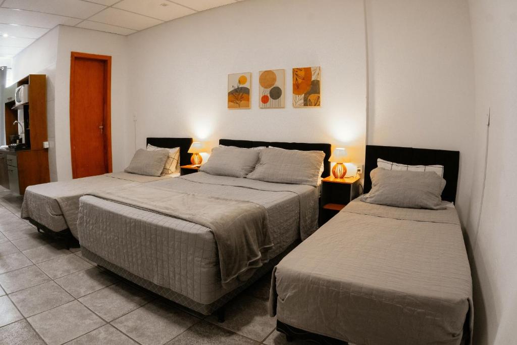 a room with two beds in a room at Large Studios 2km from Vila Germanica in Blumenau