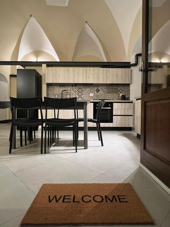 a kitchen with a table and chairs and a welcome mat at Il Poggetto Bed and Breakfast in Bovino