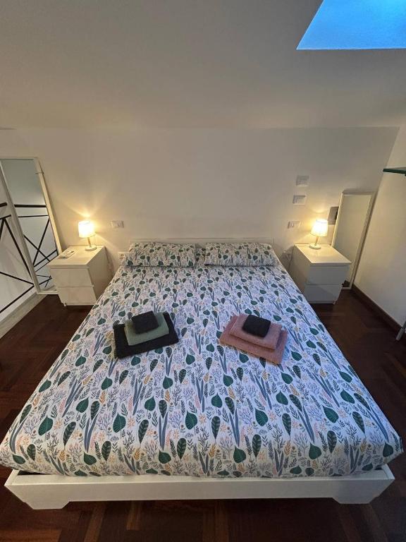 a bedroom with a bed with two nightstands and two tables at Le Tre Capanne in Marina di Carrara
