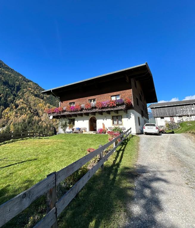a house with a fence in front of it at Bamerhof in Mittersill