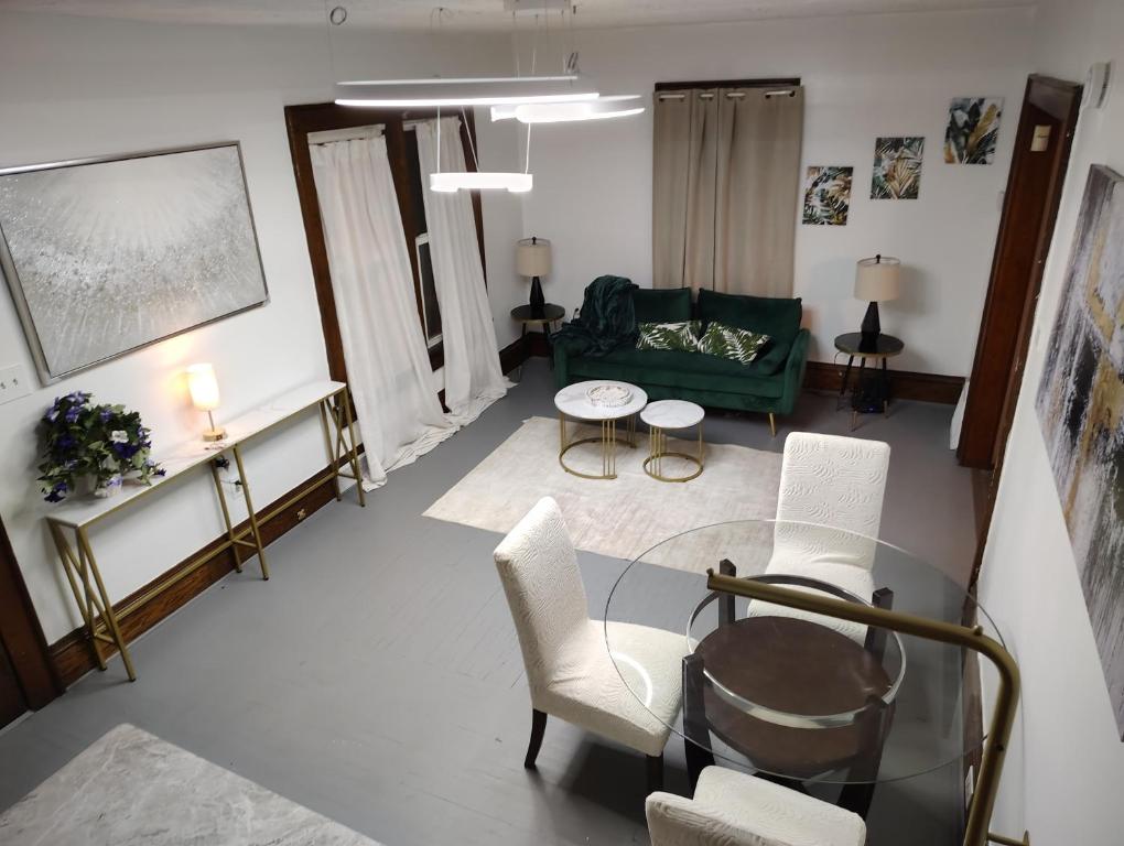 a living room with a green couch and a table at Nash Place in Akron