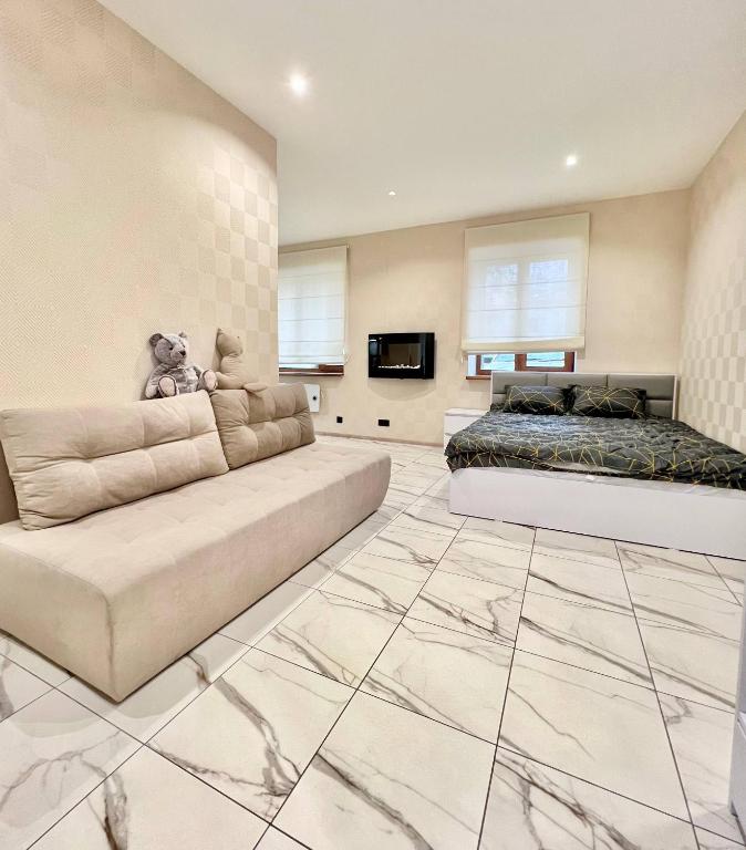 a living room with a couch and a bed at Троїцька площа 3 Квартира Самий Центр Окремий Вхід in Dnipro