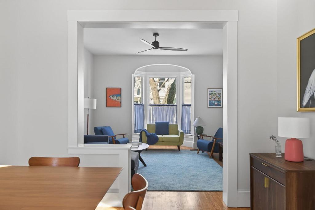 a living room with blue chairs and a mirror at Modern West End Townhome 3BR 2BA in Portland