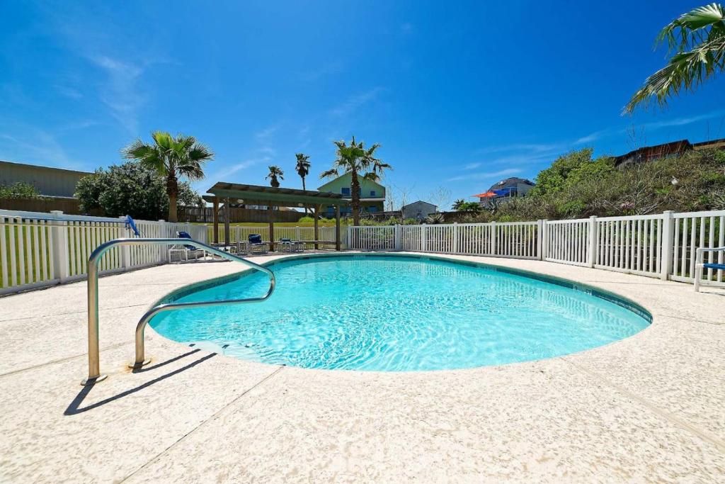 a swimming pool with a metal rail in the middle at Captain Jacks Pearl in Port Aransas