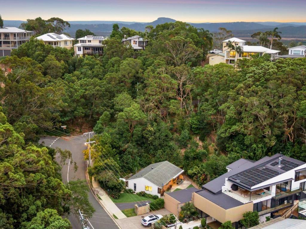 an aerial view of a town with houses and trees at Lucis Beach Retreat in Coolum Beach