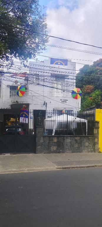 a white building with umbrellas on the side of it at Borba Beach House in Recife