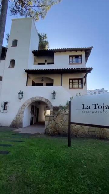 a building with a sign in front of it at La Tonja in Pinamar