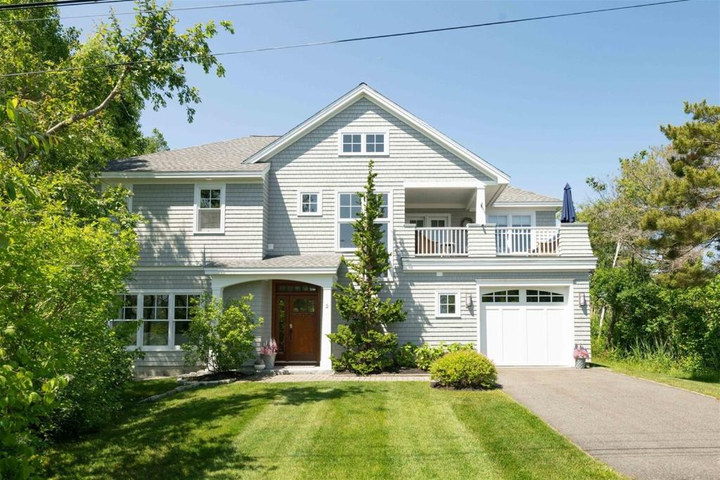 a large white house with a white garage at Starboard in Kennebunk
