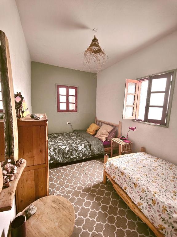 a bedroom with two beds and a couch at Hippie Chic - Room La Dune in Sidi Kaouki