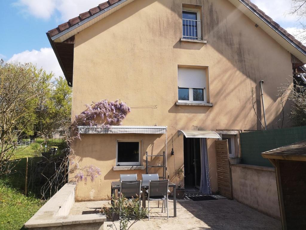 a house with a group of chairs in front of it at Une parenthése à la campagne in Cirey