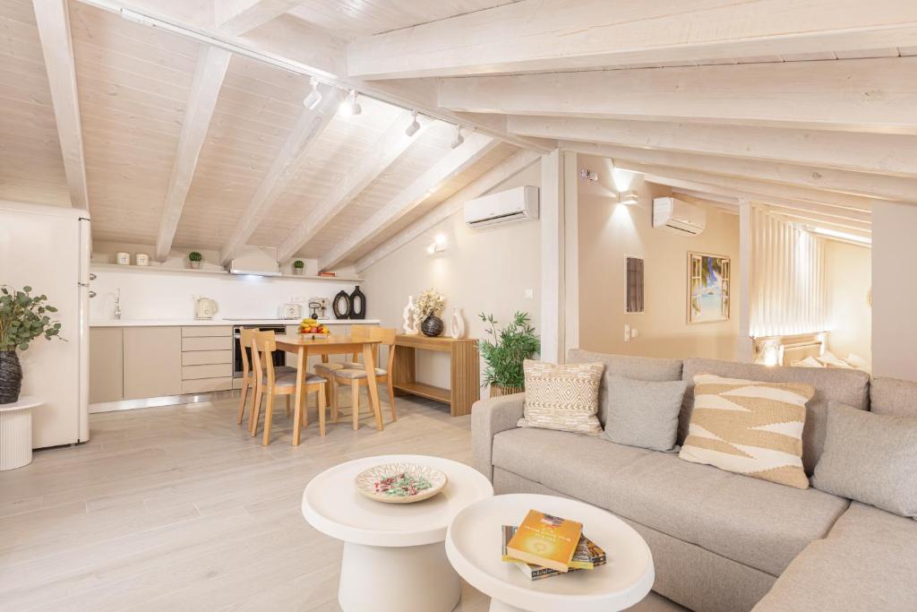 a living room with a couch and a table at Pythagoreio Blue Street Upper Floor Apartment in Pythagoreio
