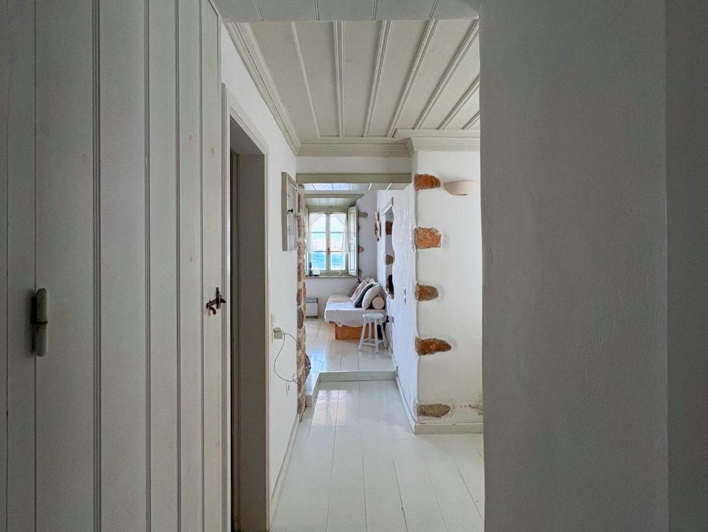 a hallway with white walls and a ceiling at Agnanti Beach House in Patmos