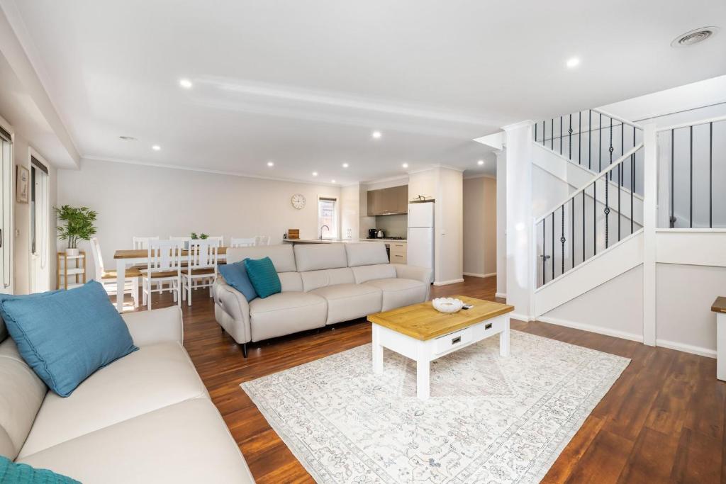 a living room with a white couch and a table at Parkside Breeze in Rosebud in Rosebud