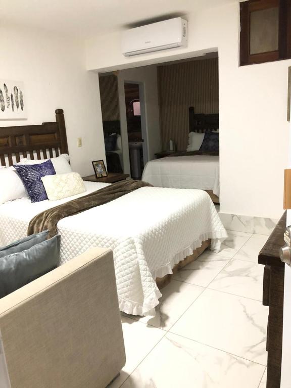 a bedroom with two beds and a laptop in it at Onyx luxury rd in La Romana