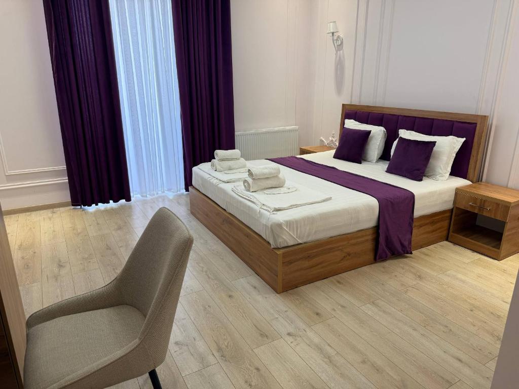 a bedroom with a bed and a chair at Amir Mumtoz Boutique hotel in Bukhara