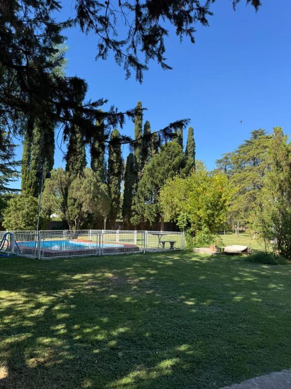 a park with a fence and a swimming pool at Arcadia entre cipreses in Pueblo Esther