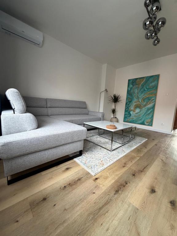a living room with a couch and a table at 2 izbový moderný byt centrum in Veľký Krtíš