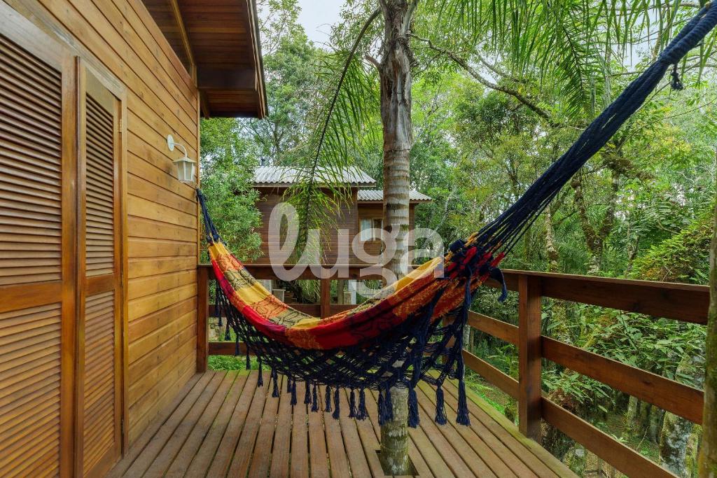 a hammock on a porch of a house at Suite Top – Cyclists' Paradise in Gramado