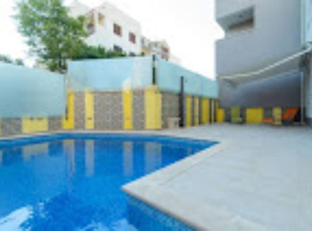 a swimming pool in a building with a building at Apartment Didi in Trogir