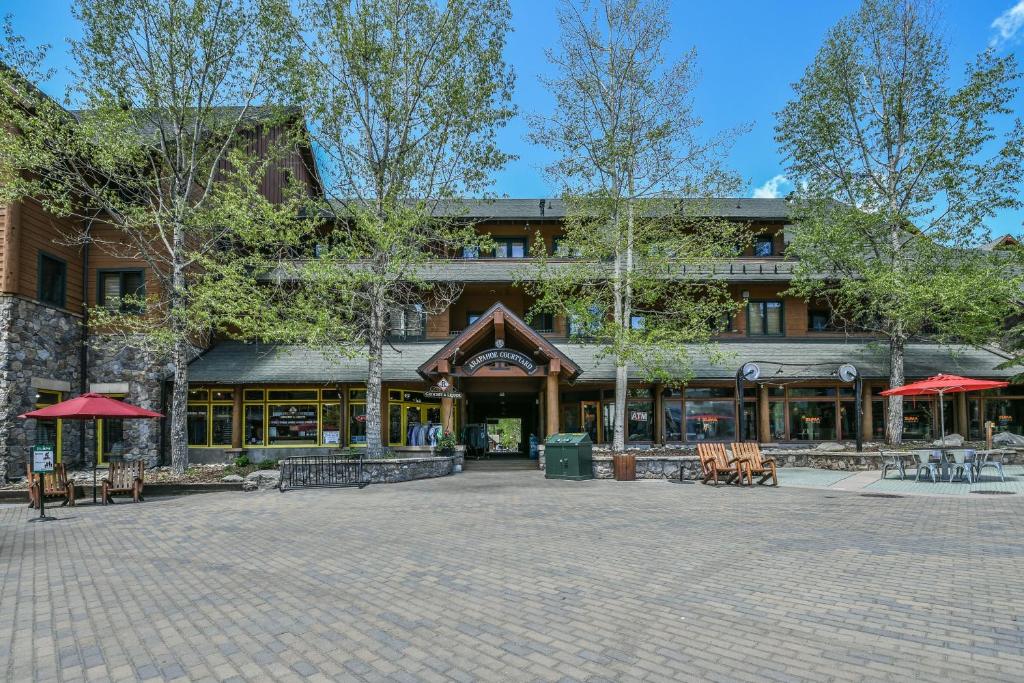 a building with tables and benches in front of it at Arapahoe Lodge 8105 by SummitCove Lodging in Colorado in Keystone