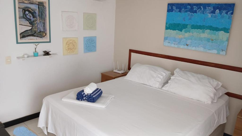 a bedroom with a bed with white sheets and pillows at Eco Paradise ART Apt.203 in Cumbuco