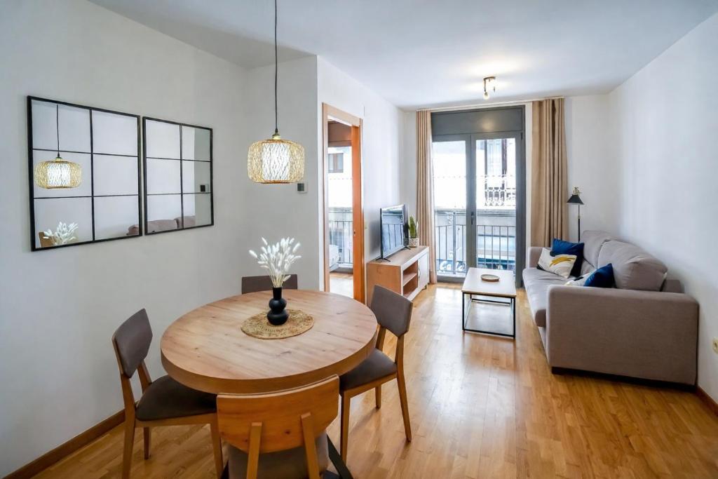 a living room with a table and a couch at Allotjament el Pont in Camprodon
