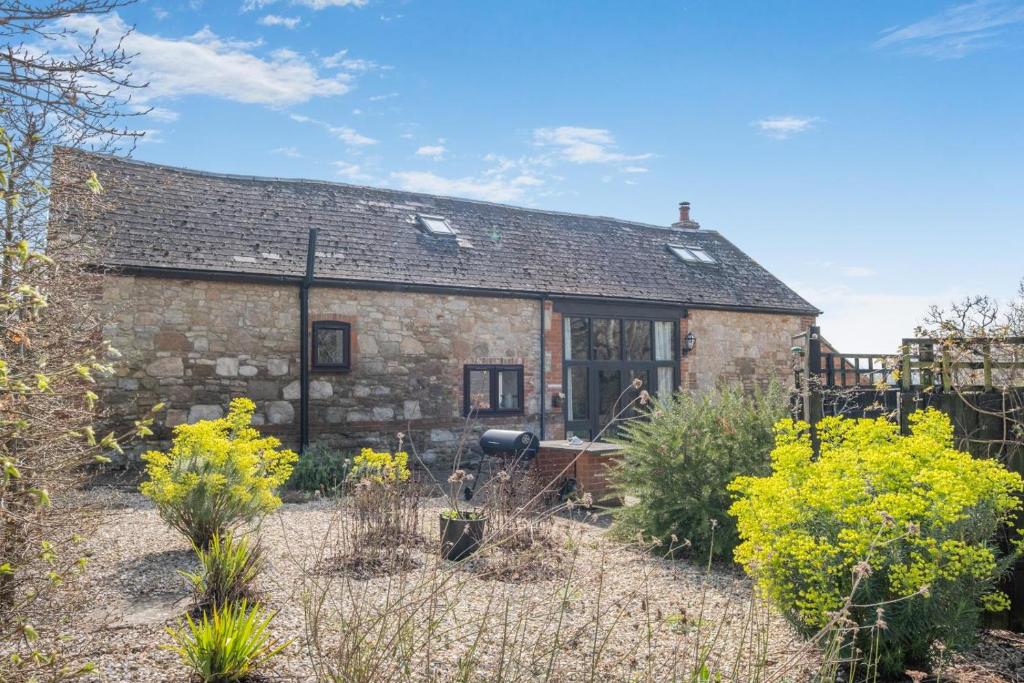 an old stone house with a garden in front of it at 4 Bed in Newport oc-88913 in Porchfield