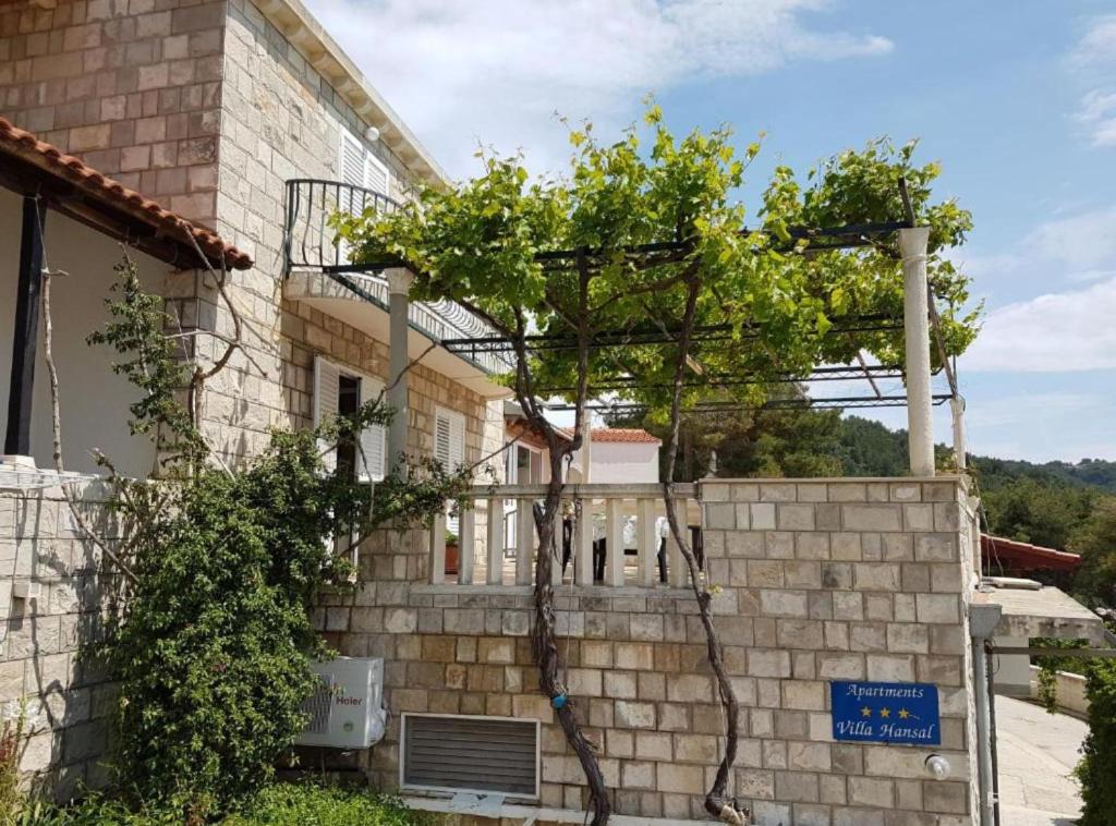 a tree on the side of a building at Villa Azure Saplunara in Saplunara