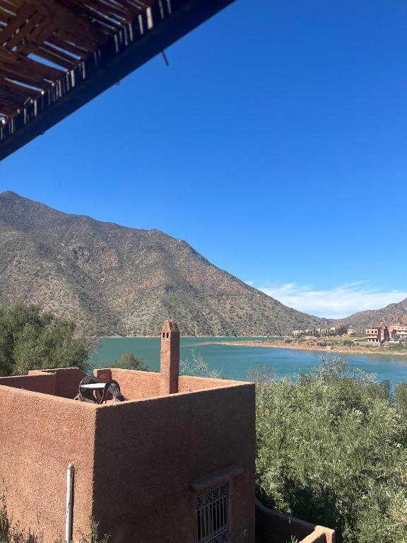 a building with a view of a body of water at la maison mondiale ouirgane in Ouirgane