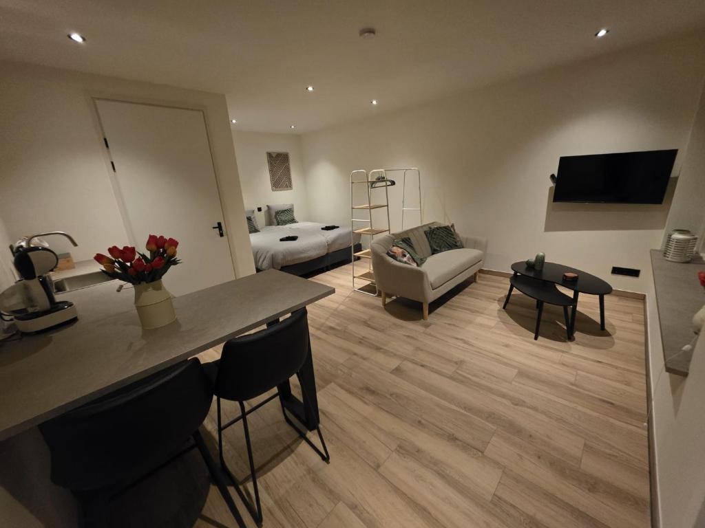 a living room with a kitchen and a living room with a couch at Alpa Farm Rouveen in Rouveen