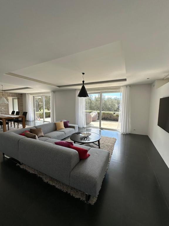 a living room with a couch and a table at Villa Nika in Bečići