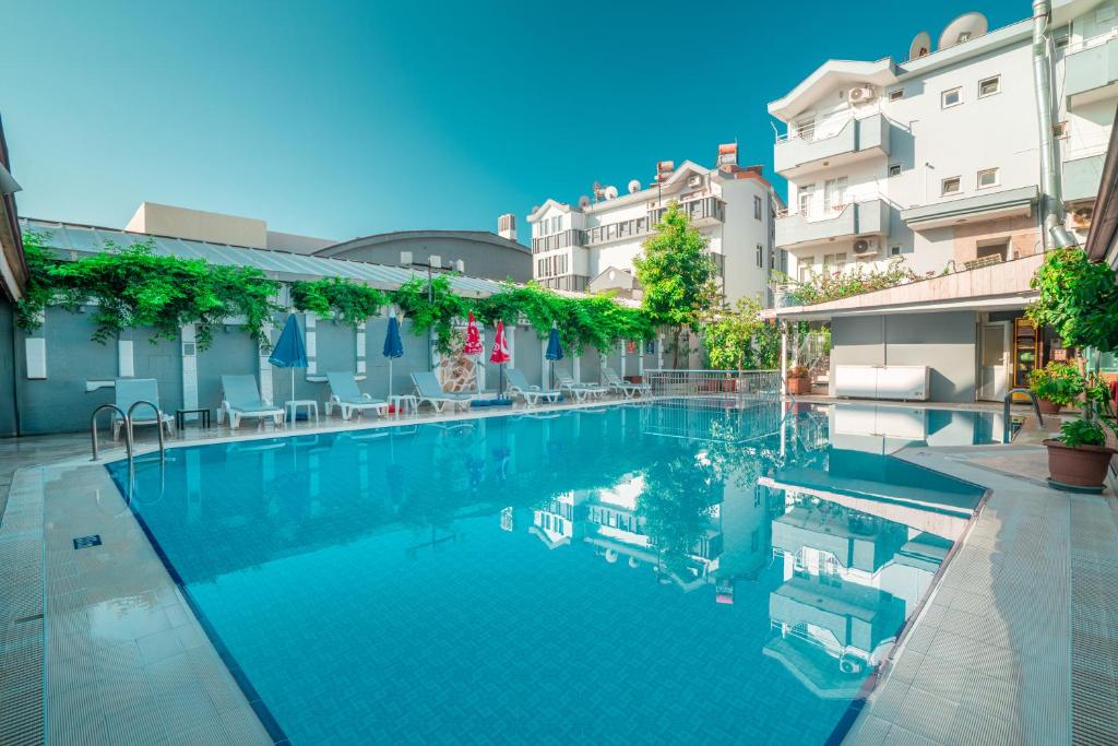 a swimming pool in the middle of a building at Side Orientt Apartments in Side