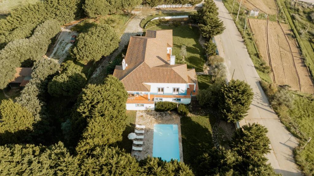 an aerial view of a house with a swimming pool at NaNa House Ericeira - Yoga & Surf in Santo Isidoro