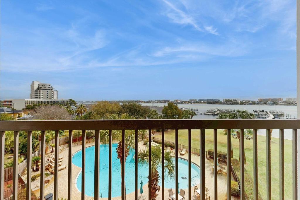 a view of a swimming pool from a balcony at Coastal condo with shared pool beaches shopping in Fort Walton Beach