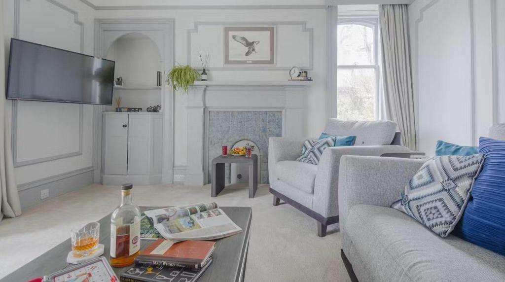 a living room with a couch and a table at Whitecraigs in Elgin